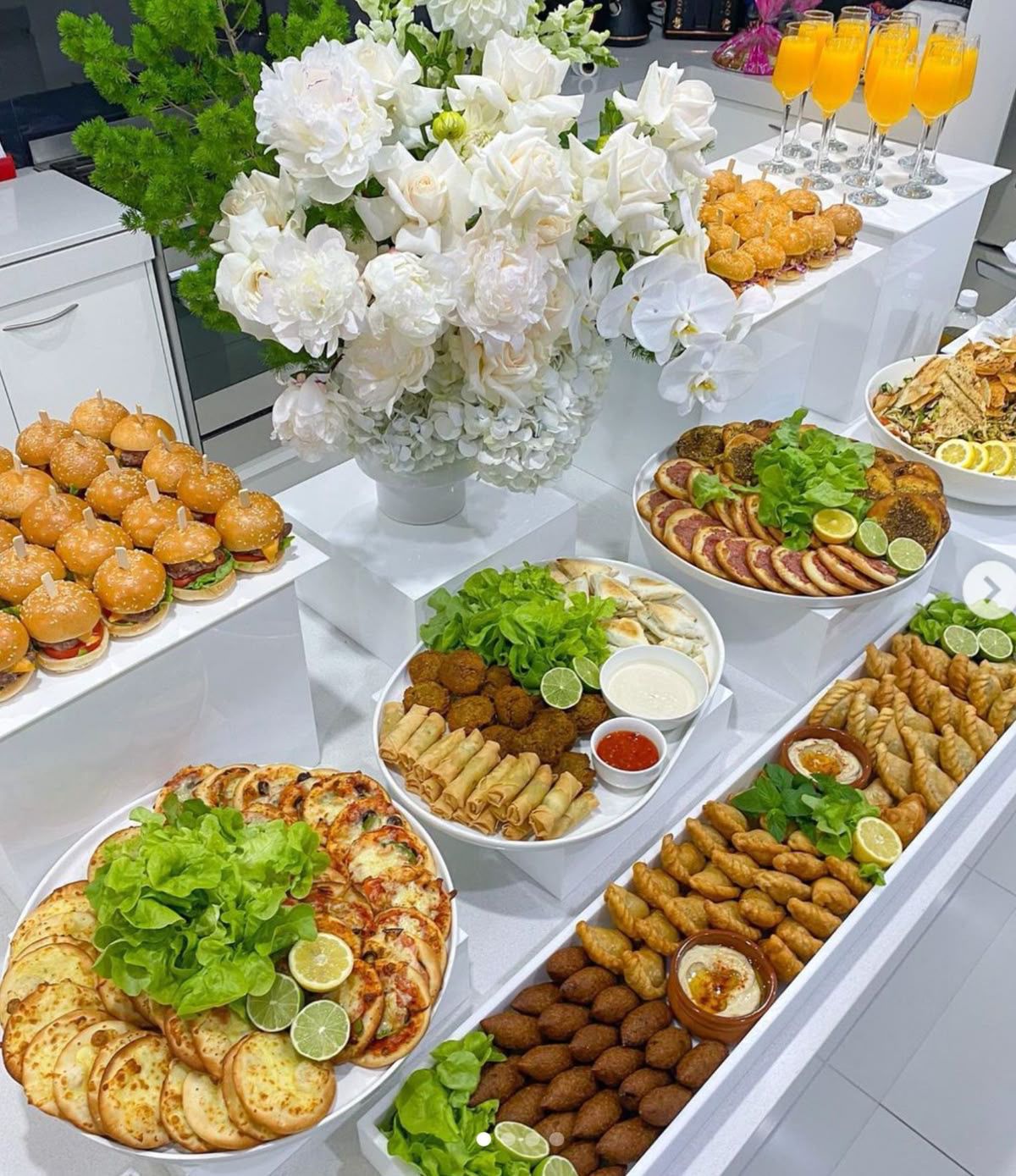 Elegant Lebanese catering with white flowers and traditional dishes